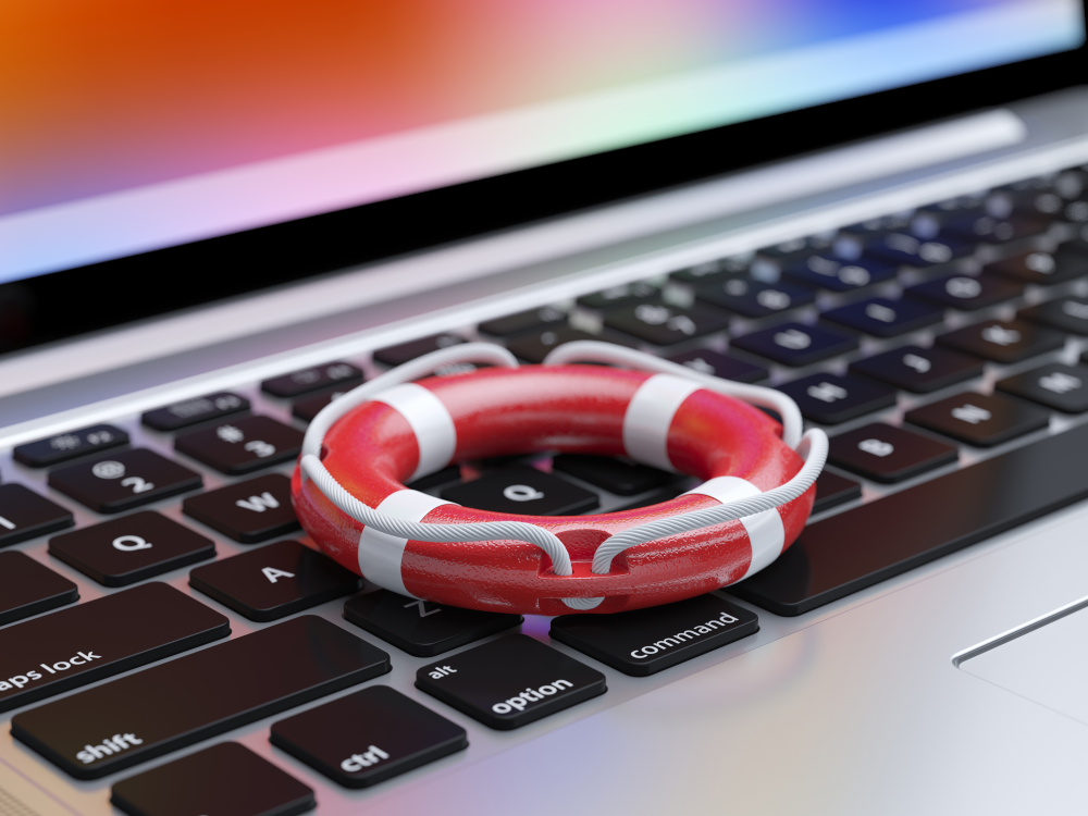 A photorealistic illustration of a tiny live preserver sitting on the keyboard of a laptop 