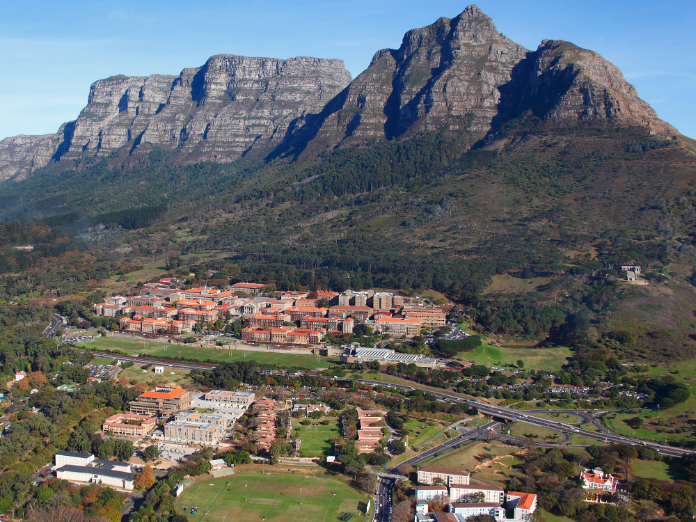 Red roofed buildings clustered in front of a mountain