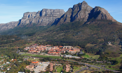 Red roofed buildings clustered in front of a mountain