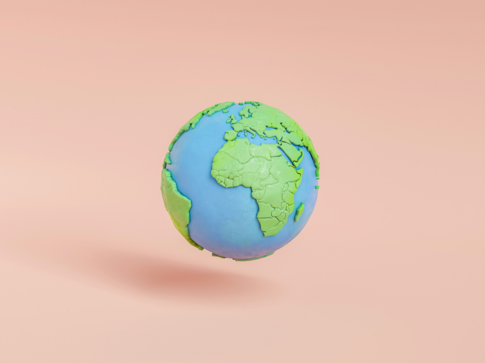 A 3-D globe with Africa facing out, floating, casting a small shadow 