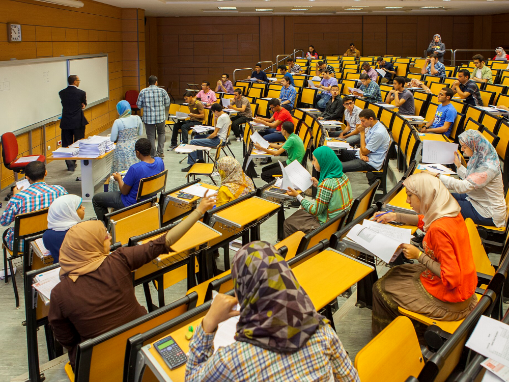 Students sitting in rows in a university lecture