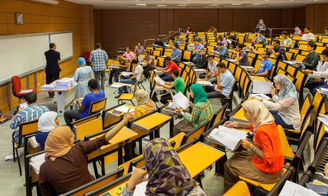 Students sitting in rows in a university lecture