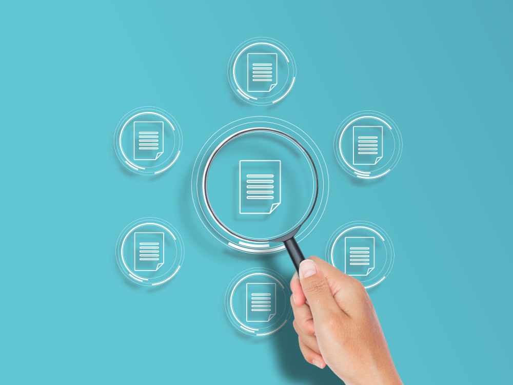 A hand holds a magnifying glass over a document icon surrounded by a ring of document icons, each within a clear glass-looking circle