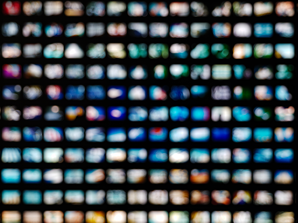 A photo illustration of rows of blurred video screens 