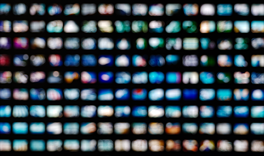 A photo illustration of rows of blurred video screens 
